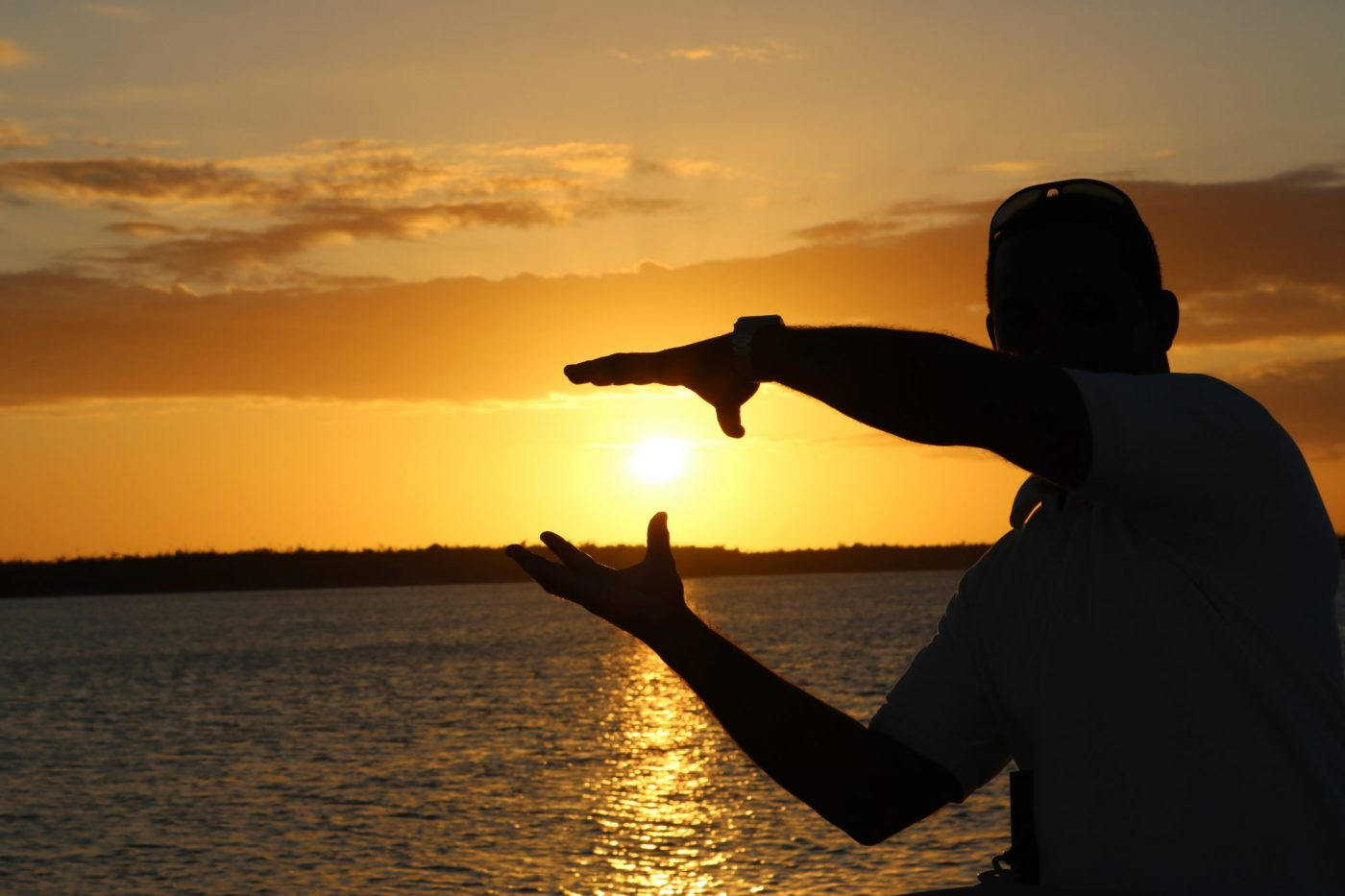 Person enjoying the orange sunset